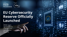 Visual representation of the EU Cybersecurity Reserve launch, featuring a digital interface with cybersecurity icons, the EU flag, and a hand interacting with virtual elements. Text reads: 'EU Cybersecurity Reserve Officially Launched – ENISA signs agreement to manage and operate the Reserve.